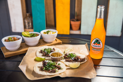 A plate of tacos and a drink