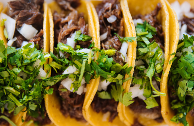 A plate of tacos and a drink